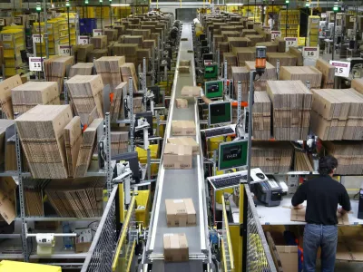 ﻿Workers pack boxes at Amazon's logistics centre in Graben near Augsburg December 16, 2013. Workers at Amazon.com's German operations were set to go on strike on Monday, in the middle of the crucial Christmas holiday season, in a dispute over pay that has been raging for months. The Verdi union said workers would strike in Amazon's logistic centres in Bad Hersfeld and Leipzig and, for the first time, in Graben. REUTERS/Michaela Rehle (GERMANY - Tags: BUSINESS EMPLOYMENT)