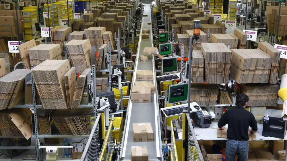 ﻿Workers pack boxes at Amazon's logistics centre in Graben near Augsburg December 16, 2013. Workers at Amazon.com's German operations were set to go on strike on Monday, in the middle of the crucial Christmas holiday season, in a dispute over pay that has been raging for months. The Verdi union said workers would strike in Amazon's logistic centres in Bad Hersfeld and Leipzig and, for the first time, in Graben. REUTERS/Michaela Rehle (GERMANY - Tags: BUSINESS EMPLOYMENT)