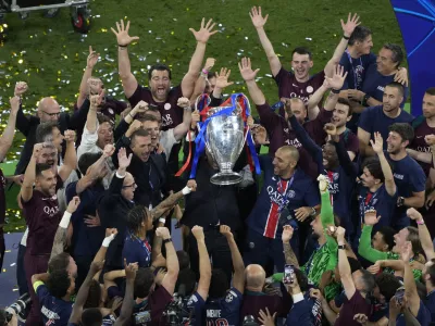 Players of PSG lift the trophy after winning the Champions League tournament at the Allianz Arena in Munich, Germany, Saturday, May 31, 2025. (AP Photo/Michael Probst)