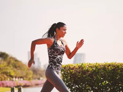 ﻿Sport girl in sporty outfit running at the lane in the park