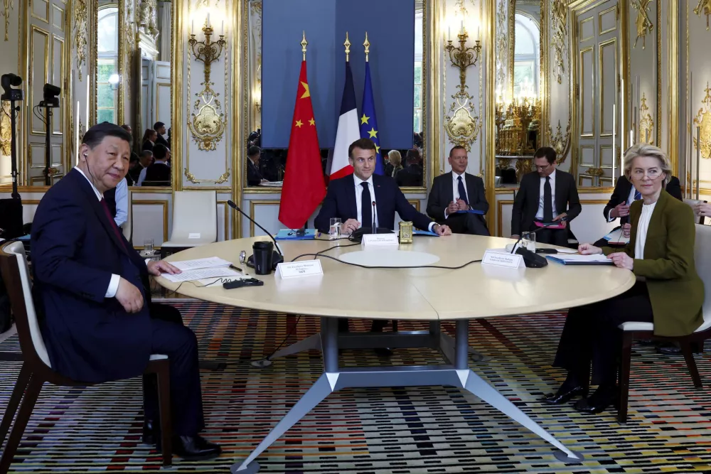 French President Emmanuel Macron, center, China's President Xi Jinping and European Commission President Ursula von der Leyen attend a trilateral meeting at the Elysee Palace as part of the Chinese president's two-day state visit in France, Monday, May 6, 2024 in Paris. French President Emmanuel Macron is welcoming China's Xi Jinping for a two-day state visit to France and is seeking to press Xi to use his influence on Moscow to move toward ending the war in Ukraine. (Gonzalo Fuentes/Pool via AP)