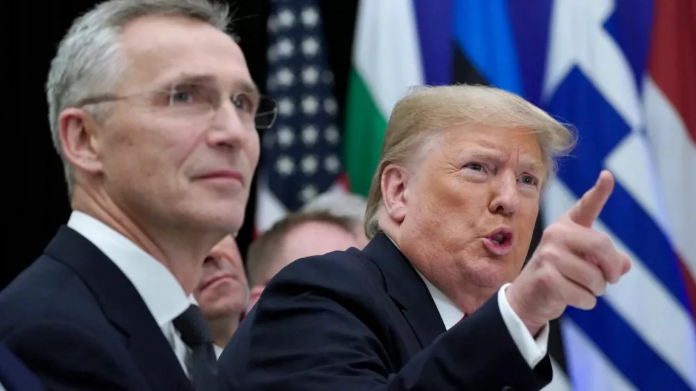 FILE PHOTO: U.S. President Donald Trump gestures next to NATO Secretary General Jens Stoltenberg as they attend a working lunch during the NATO leaders summit in Watford, Britain, December 4, 2019. REUTERS/Kevin Lamarque/File Photo