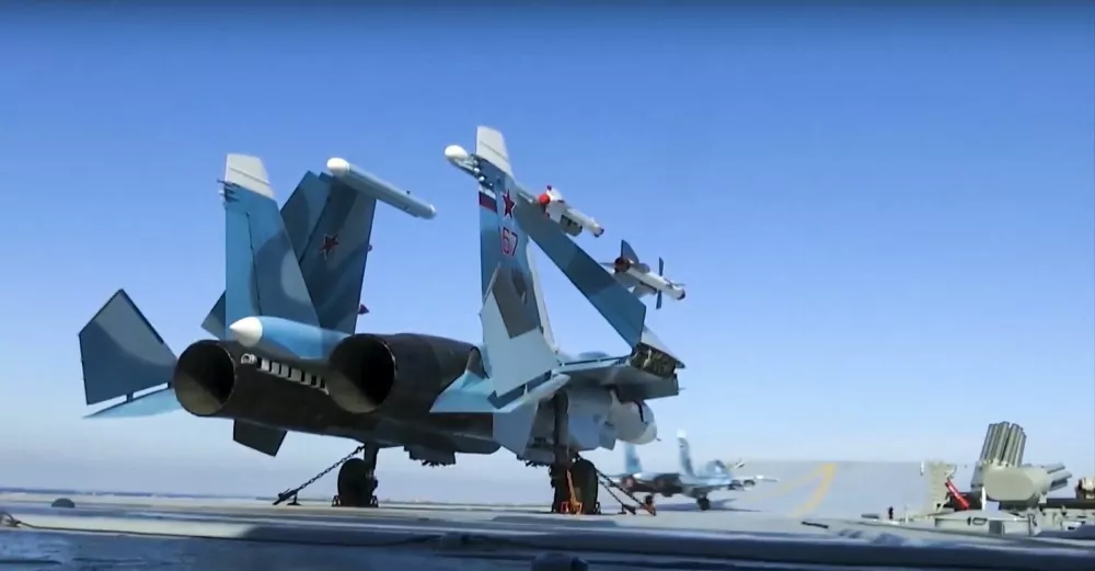 ﻿In this photo made from the footage taken from Russian Defense Ministry official web site on Tuesday, Nov. 15, 2016, Russian Su-33 fighter jets are parked on the flight deck of the Admiral Kuznetsov aircraft carrier in the eastern Mediterranean Sea. The Russian military on Tuesday launched a series of strikes on militant targets in Syria involving carrier-borne fighters, marking the Admiral Kuznetsov's combat debut. (Russian Defense Ministry Press Service/ Photo via AP)