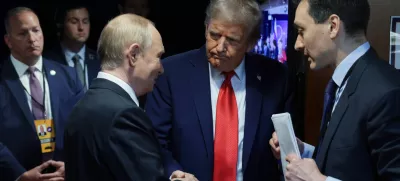 HANDOUT - 15 August 2025, US, Alaska: US President Donald Trump (C) and Russian President Vladimir Putin (L) speak privately ahead of their joint press conference following their meeting in Alaska. Photo: -/Kremlin/dpa - ATTENTION: editorial use only and only if the credit mentioned above is referenced in full