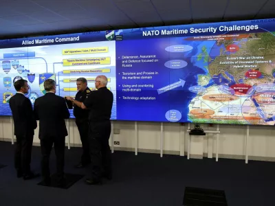 France's President Emmanuel Macron and Britain's Prime Minister Keir Starmer listen to a NATO military officer during a Coalition of the Willing meeting at a military base at Northwood Headquarters in north-west London, Britain, on July 10, 2025. LUDOVIC MARIN/Pool via REUTERS
