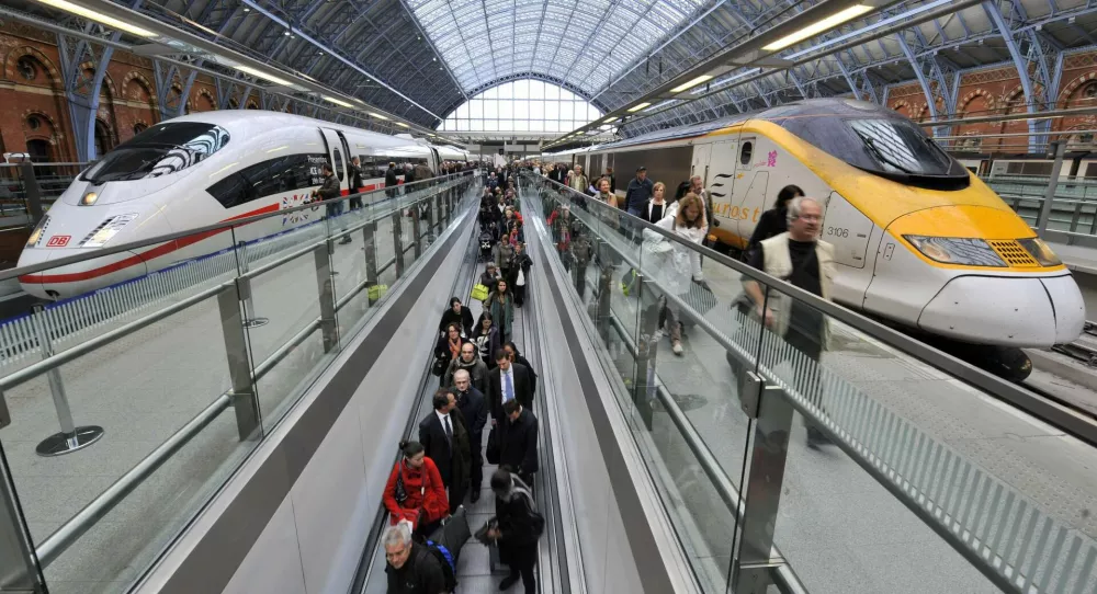 FILE - This Tuesday, Oct. 19, 2010 photo from files shows passengers walking by a German Intercity Express (ICE) high speed train, left, and a Eurostar high speed train at St. Pancras International Station in London. From 2013, Germany's Deutsche Bahn will provide a high speed train service between Germany and London. Two Canadian pension plans are paying 2.1 billion pounds ($3.4 billion) for rights to operate the high-speed rail link between London and the Channel Tunnel, the British government said Friday, Nov. 5, 2010. Borealis Infrastructure and Ontario Teachers' Pension Plan teamed up to win a 30-year franchise to operate the 68-mile (109-kilometer) line, the Department for Transport said. The government will continue to own the line, associated infrastructure and land. The route currently links London to Brussels and Paris, but by 2013 is expected to include links to Amsterdam, Holland, and both Cologne and Frankfurt in Germany. (AP Photo/Lennart Preiss, File)