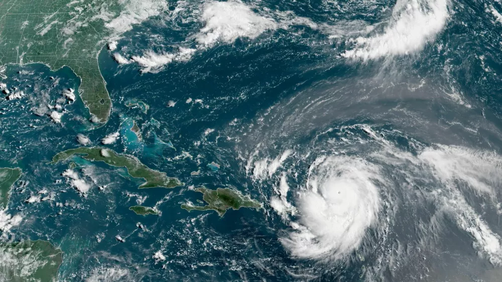 Hurricane Erin, which is the first hurricane of the 2025 Atlantic season and has developed into a dangerous Category 4 hurricane, moves westward near Puerto Rico in a composite satellite image August 16, 2025. CIRA/NOAA/Handout via REUTERS  THIS IMAGE HAS BEEN SUPPLIED BY A THIRD PARTY