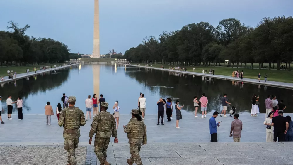 Members of the District of Columbia National Guard patrol along the National Mall, Saturday, Aug. 16, 2025, in Washington. (AP Photo/Julia Demaree Nikhinson)