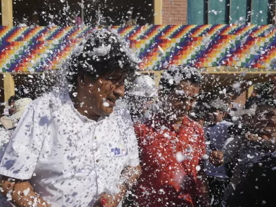 Supporters throw confetti on former President Evo Morales after a meeting with a peasants' federation, before he voted in presidential and legislative elections in Villa 14 de Septiembre, in the Chapare region of Bolivia, Sunday, Aug. 17, 2025. (AP Photo/Jorge Saenz)