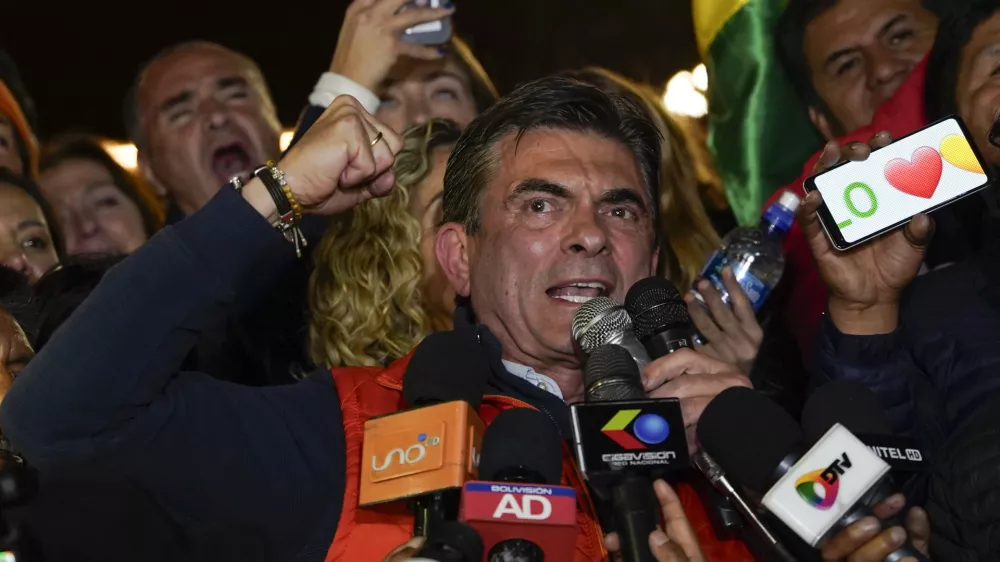 Presidential candidate Rodrigo Paz, center, addresses supporters after early results showed him leading in the presidential election in La Paz, Bolivia, Sunday, Aug. 17, 2025. (AP Photo/Freddy Barragan)