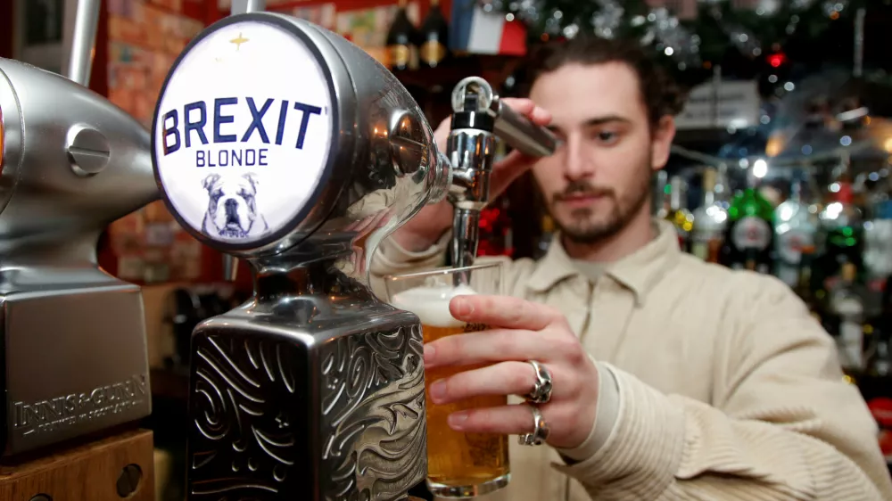 ﻿FILE PHOTO: Thibault, barman at the Cricketer English Pub, serves a Brexit draft beer in Paris, France, December 17, 2018. REUTERS/Charles Platiau/File Photo