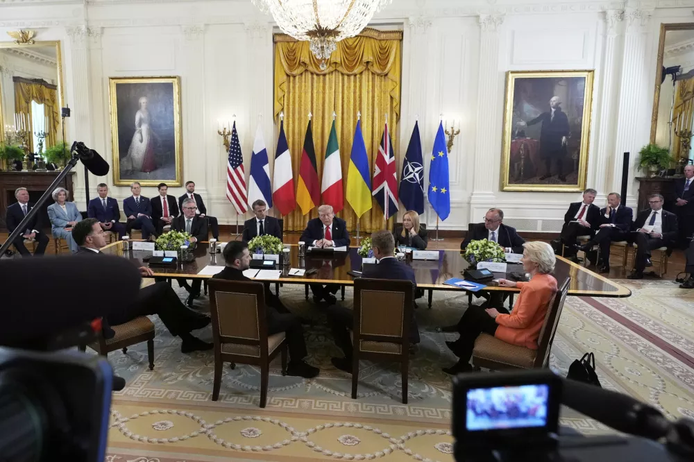 President Donald Trump, center, meets with British Prime Minister Keir Starmer, seated from background left, France's President Emmanuel Macron, Italy's Prime Minister Giorgia Meloni, Germany's Chancellor Friedrich Merz, and from foreground left, NATO Secretary General Mark Rutte, Ukrainian President Volodymyr Zelenskyy, Finland's President Alexander Stubb and European Commission President Ursula von der Leyen, in the East Room of the White House, Monday, Aug. 18, 2025, in Washington. (AP Photo/Alex Brandon)