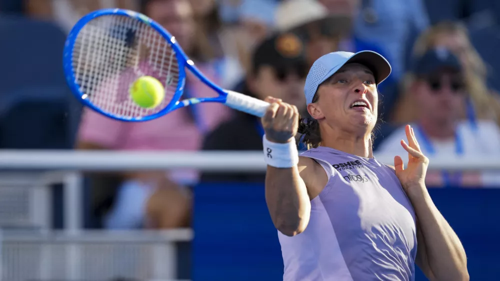 Aug 18, 2025; Cincinnati, OH, USA; Iga Swiatek (POL) returns a shot against Jasmine Paolini (ITA) during the Cincinnati Open at the Lindner Family Tennis Center. Mandatory Credit: Aaron Doster-Imagn Images