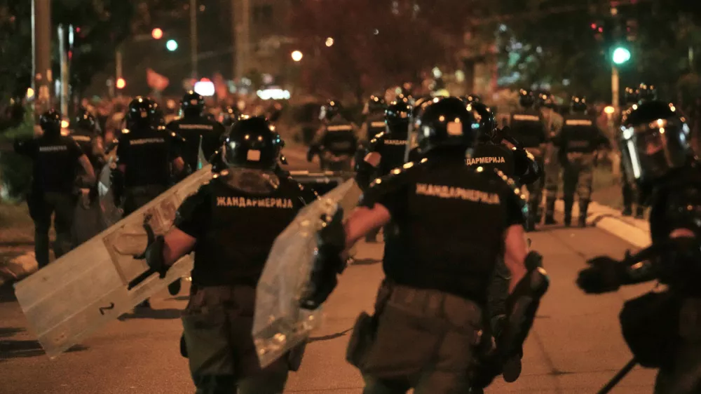 Serbian gendarmerie officers chase protesters during an anti-government protest in Belgrade, Serbia, Monday, Aug. 18, 2025. (AP Photo/Darko Vojinovic)