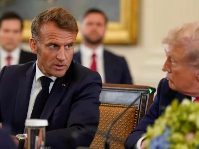 French President Emmanuel Macron speaks to U.S. President Donald Trump during a meeting with Ukrainian President Volodymyr Zelenskiy (not pictured) and European leaders amid negotiations to end the Russian war in Ukraine, at the White House in Washington, D.C., U.S., August 18, 2025. REUTERS/Al Drago