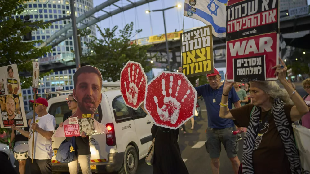 Supporters of Israeli hostages held in the Gaza Strip attend a rally demanding their release from Hamas captivity and calling for an end to the war, in Tel Aviv, Israel, Tuesday, Aug. 19, 2025. (AP Photo/Ohad Zwigenberg)