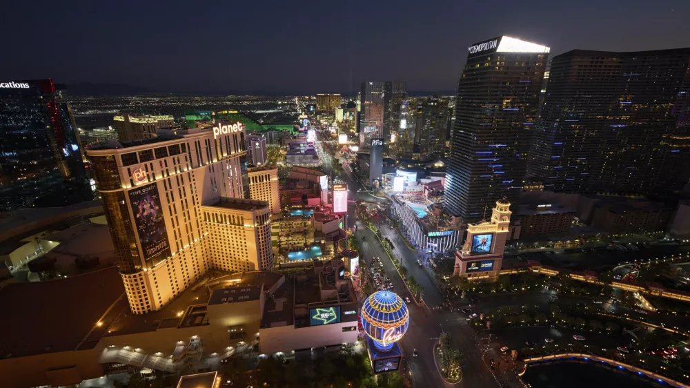Cars drive along the Las Vegas Strip, Saturday, Aug. 2, 2025, in Las Vegas. (AP Photo/John Locher)