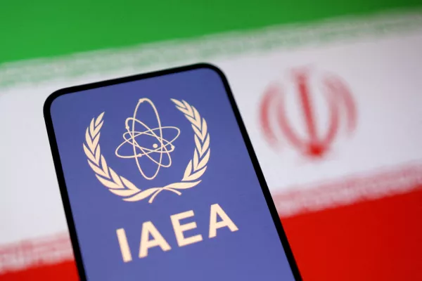 FILE PHOTO: International Atomic Energy Agency (IAEA) logo and Iranian flag is seen in this illustration taken June 16, 2025. REUTERS/Dado Ruvic/Illustration/File Photo