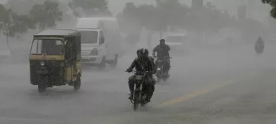 Commuters travel on a road during heavy rain in Karachi, Pakistan, August 20, 2025. REUTERS/Shakil Adil