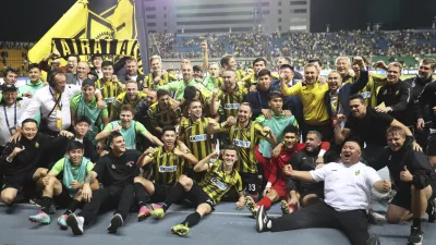Kairat players celebrate after winning the Champions League playoff second leg soccer match between Kairat and Celtic at Ortalyk stadium in Almaty, Kazakhstan, Wednesday, Aug. 27, 2025. (AP Photo/Alikhan Sariyev)