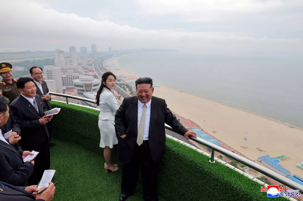 North Korean leader Kim Jong Un and his daughter Kim Ju Ae stand on a balcony facing the beach during a ceremony to celebrate the completion of the Wonsan Kalma Coastal Tourist Zone, in Wonsan, in North Korea, June 24, 2025. KCNA via REUTERS  ATTENTION EDITORS - THIS IMAGE WAS PROVIDED BY A THIRD PARTY. REUTERS IS UNABLE TO INDEPENDENTLY VERIFY THIS IMAGE. NO THIRD PARTY SALES. SOUTH KOREA OUT. NO COMMERCIAL OR EDITORIAL SALES IN SOUTH KOREA.   TPX IMAGES OF THE DAY