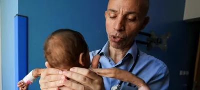 Palestinian doctor Ahmed Basal examines a child for malnutrition at Al-Rantisi Hospital in Gaza City, August 7, 2025. REUTERS/Dawoud Abu Alkas   TPX IMAGES OF THE DAY