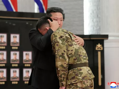 North Korean leader Kim Jong hugs a soldier as he attends a national commendation ceremony for the commanders and fighters of the Korean People's Army's overseas operations unit, at the headquarters of the Central Committee of the Korean Workers' Party, in Pyongyang, North Korea, in this photo released on August 22, 2025 by North Korea's Korean Central News Agency (KCNA). KCNA via REUTERS ATTENTION EDITORS - THIS IMAGE WAS PROVIDED BY A THIRD PARTY. REUTERS IS UNABLE TO INDEPENDENTLY VERIFY THIS IMAGE. NO THIRD PARTY SALES. SOUTH KOREA OUT. NO COMMERCIAL OR EDITORIAL SALES IN SOUTH KOREA.