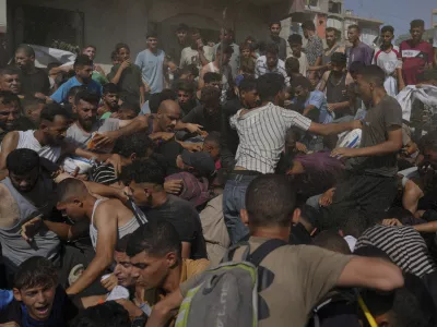 Palestinians struggle to collect humanitarian aid airdropped into Gaza City, northern Gaza Strip, Thursday, Aug. 14, 2025. (AP Photo/Jehad Alshrafi)