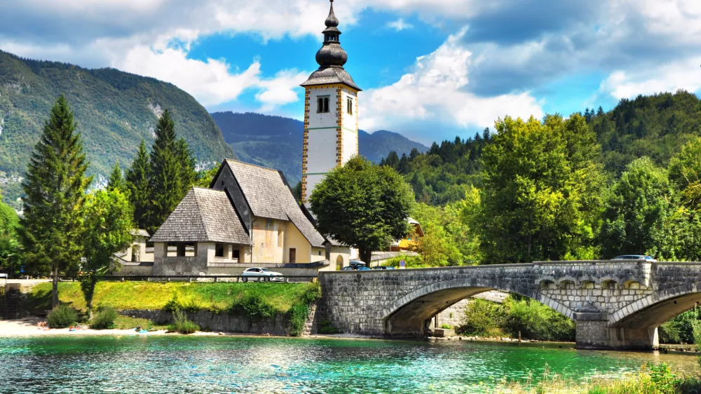 Bohinj Lake, Church of St John the Baptist with bridge. Triglav National Park, Julian Alps, Slovenia.