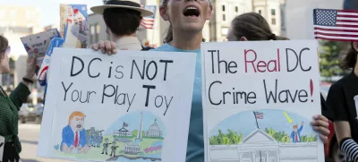 A demonstrator protest against President Donald Trump's use of federal law enforcement and National Guard troops in the city during a rally along the U street corridor in northwest Washington, Saturday, Aug. 23, 2025. (AP Photo/Jose Luis Magana)
