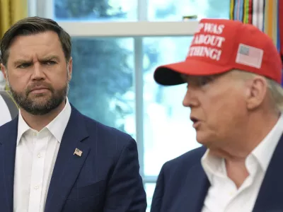Vice President JD Vance looks on as President Donald Trump speaks in the Oval Office of the White House, Friday, Aug. 22, 2025, in Washington. (AP Photo/Jacquelyn Martin)