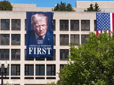 A portrait of President Donald Trump hangs on the Labor Department headquarters near the Capitol in Washington, Monday, Aug. 25, 2025. (AP Photo/J. Scott Applewhite)
