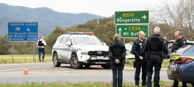 Victorian Police stand at the scene of a shooting in Porepunkah, Victoria, Australia, August 26, 2025. Parts of a rural town, including a primary school, have been placed into lockdown after two police officers were reportedly shot dead and a third critically injured. AAP/Simon Dallinger via REUTERS  ATTENTION EDITORS - THIS IMAGE WAS PROVIDED BY A THIRD PARTY. NO RESALES. NO ARCHIVE. AUSTRALIA OUT. NEW ZEALAND OUT. NO COMMERCIAL OR EDITORIAL SALES IN NEW ZEALAND. NO COMMERCIAL OR EDITORIAL SALES IN AUSTRALIA.