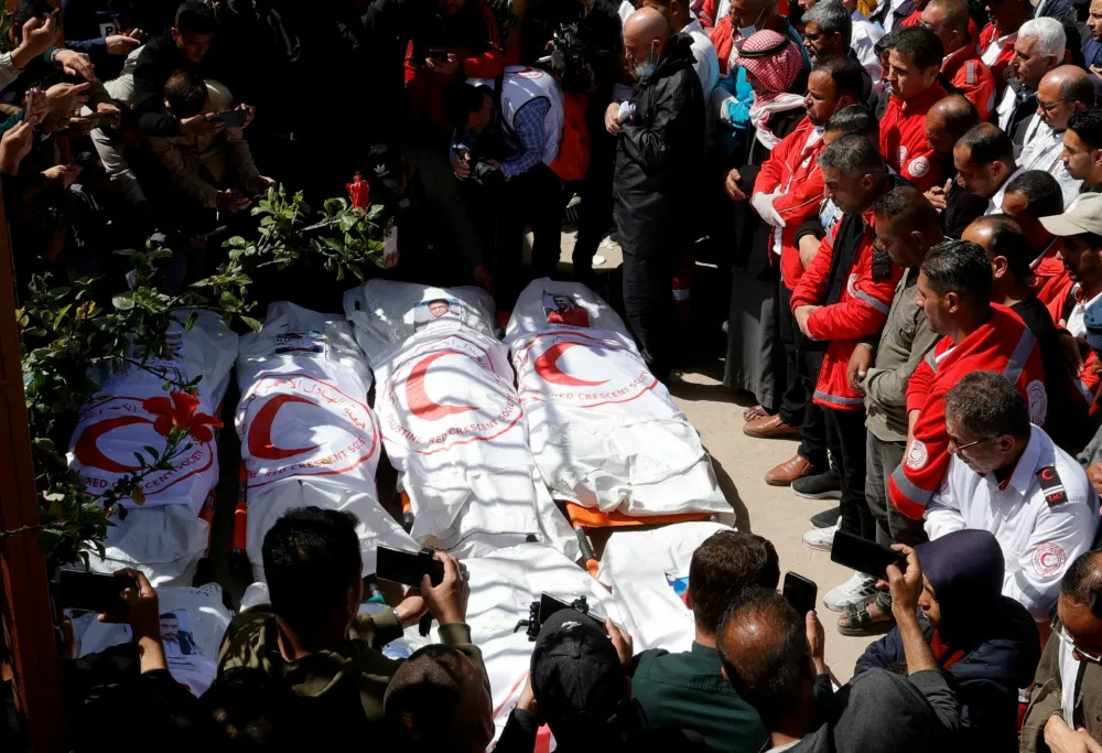 FILE PHOTO: Palestinians mourn medics, who came under Israeli fire while on a rescue mission, after their bodies were recovered, according to the Red Crescent, at Nasser hospital in Khan Younis in the southern Gaza Strip March 31, 2025. REUTERS/Hatem Khaled/File Photo