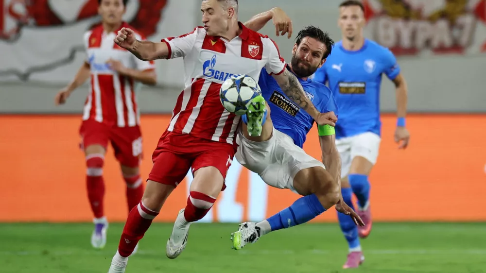 Soccer Football - UEFA Champions League - Play Off - Second Leg - Pafos v Red Star Belgrade - Alphamega Stadium, Kolossi, Cyprus - August 26, 2025 Pafos' David Goldar in action with Red Star Belgrade's Bruno Duarte REUTERS/Yiannis Kourtoglou