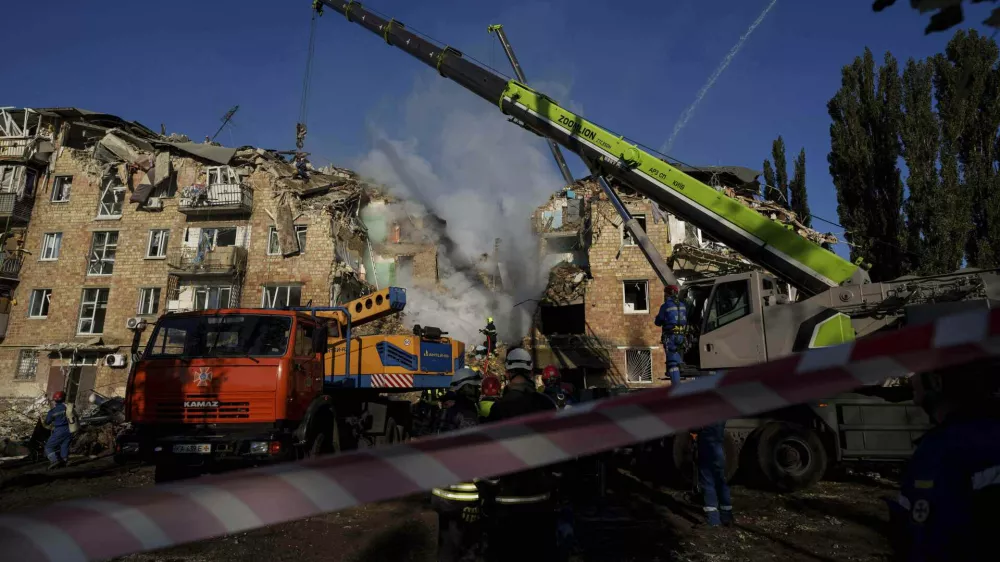 Rescue workers clear the rubble of a residential house destroyed by a Russian strike in Kyiv, Ukraine, on Thursday, Aug. 28, 2025. (AP Photo/Evgeniy Maloletka)