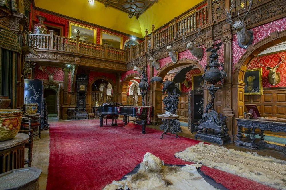 Grand Hall, Kinloch Castle. See SWNS story SWOCcastle. July 29, 2021.One of Prince Charles' favourite castles is looking for a new owner to save it from ruin as the iconic landmark crumbles in need of repair. Kinloch Castle on the Island of Rum in Scotland is on the market for a new owner who could put the money required into fixing up the crumbling castle. With a nominal value of just £1, this is an extremely rare opportunity to take ownership of a 120-year-old castle that Prince Charles himself has been passionate about saving. Repairs on the crumbling turreted red-sandstone house are estimated at an eye-watering £20 million to restore the castle to it's former glory. A private individual or a charity, foundation or private company who can provide such an amount for the castle repairs are in with a chance of owning the incredible house. Any new hopeful owners will have to prove that they have the resources to save this Category A landmark and show plans for bettering the future of the small isle where the castle sits.,Image: 624153007, License: Rights-managed, Restrictions: This image is not available for use at a stock rate unless with prior agreement. This image hereby disclosed to your organisation is so disclosed on the condition that your organisation will take all steps necessary to ensure that any identifiable personal data is processed in full compliance with the Data Protection Act 2018follow us on twitter - @swnsbrowse our website - swns.comemail pix@swns.com, Model Release: no