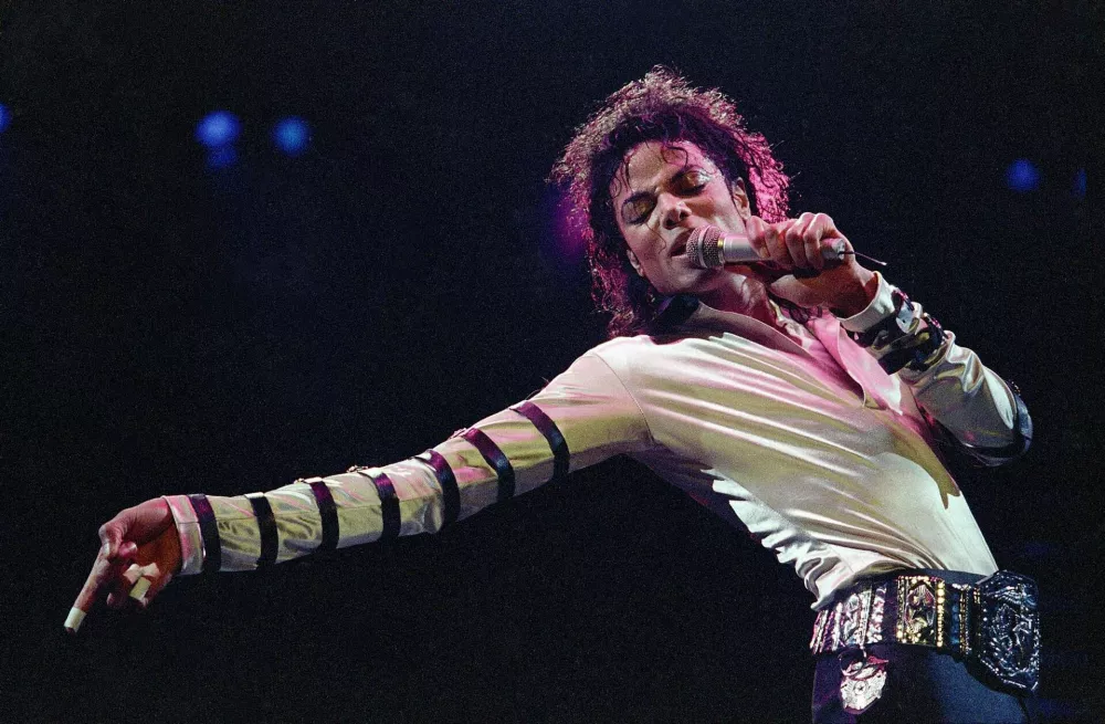 FILE - In this Feb. 24, 1988 file photo, Michael Jackson performs during his 13-city U.S. tour in Kansas City, Mo. The estate of Michael Jackson has landed the late King of Pop the biggest recording deal in history: a $200 million guaranteed contract with Sony Music Entertainment for 10 projects over seven years, according to a person familiar with the deal. (AP Photo/Cliff Schiappa, File)