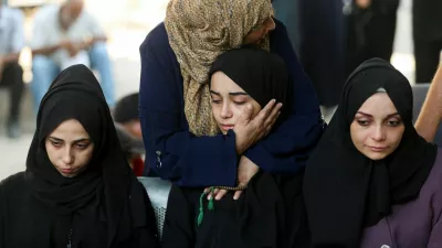 Mourners react during the funeral of Palestinians who were killed by Israeli fire while trying to receive aid and another killed in a strike on Friday, according to medics, at Al-Shifa Hospital in Gaza City, August 30, 2025. REUTERS/Mahmoud Issa