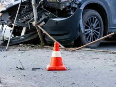 road cone against the background of a car broken in a road accident. Selective focus