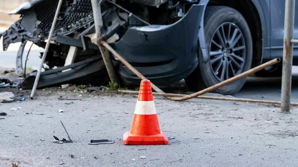 road cone against the background of a car broken in a road accident. Selective focus