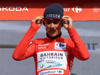 Cycling - Vuelta a Espana - Stage 7 - Andorra la Vella to Cerler - Andorra la Vella, Andorra - August 29, 2025 Bahrain Victorious' Torstein Traeen celebrates on the podium wearing the red jersey after stage 7 REUTERS/Bruna Casas