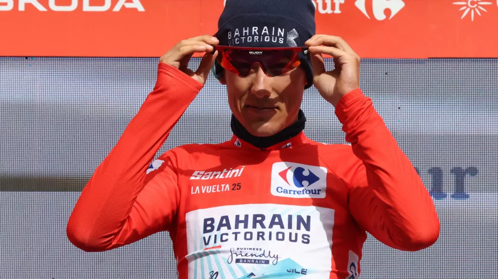 Cycling - Vuelta a Espana - Stage 7 - Andorra la Vella to Cerler - Andorra la Vella, Andorra - August 29, 2025 Bahrain Victorious' Torstein Traeen celebrates on the podium wearing the red jersey after stage 7 REUTERS/Bruna Casas