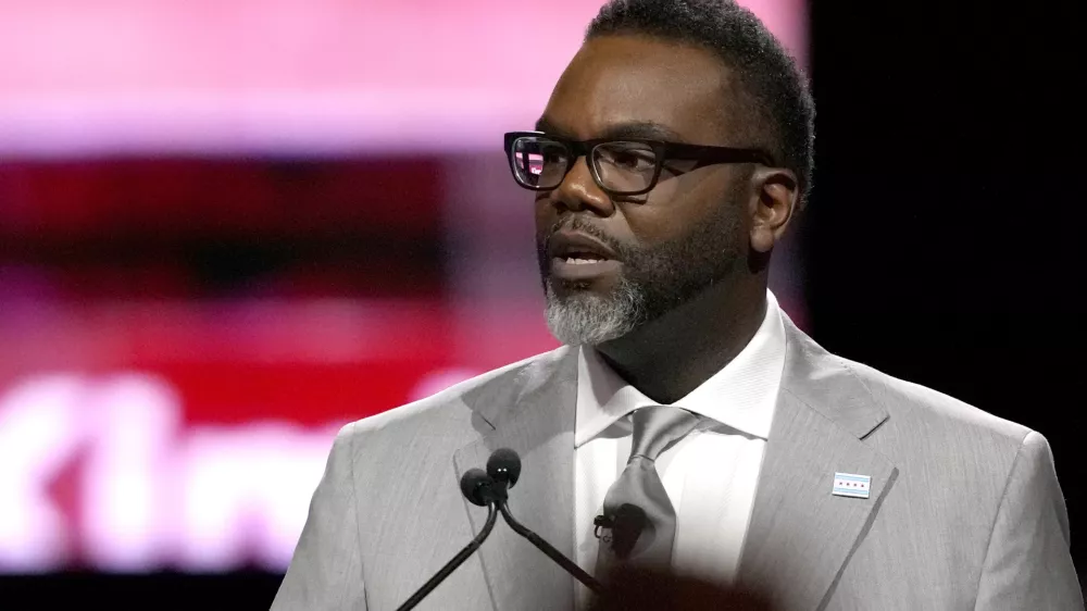 A member of the audience raises their fist as Chicago Mayor Brandon Johnson delivers his inaugural address Monday, May 15, 2023, in Chicago. (AP Photo/Charles Rex Arbogast)