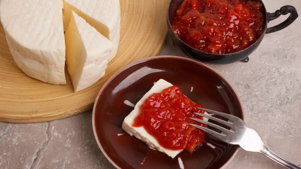 Brazilian dessert Romeo and Juliet, goiabada jam of guava and cheese Minas on marble table. Selective focus