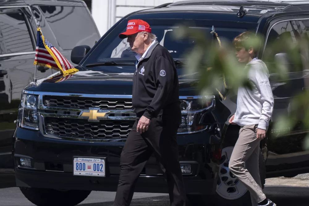 President Donald Trump, left, walks with his grandson Spencer Trump at the Trump National Golf Club in Sterling, Va., Saturday, Aug. 30, 2025. (AP Photo/Manuel Balce Ceneta)