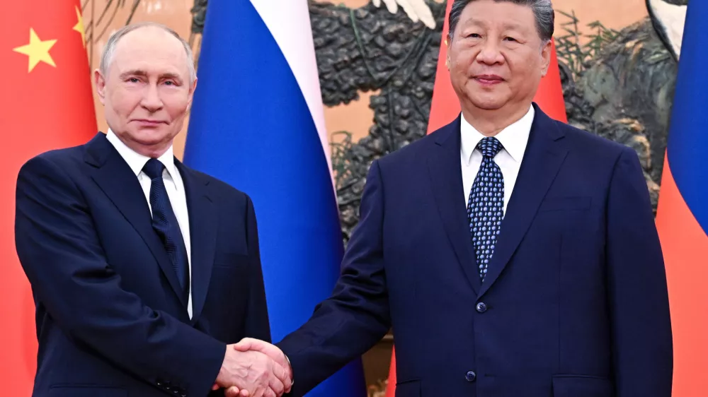 Russian President Vladimir Putin, left, and Chinese President Xi Jinping shake hands ahead of their meeting at The Great Hall of the People in Beijing, China, Tuesday, Sept. 2, 2025. (Sergei Bobylev, Sputnik, Kremlin Pool Photo via AP)