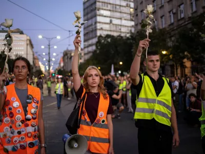 Students hold flowers on a street to commemorate the 16 victims, who were killed after a railway concrete canopy fell in November 2024 in Novi Sad, triggering accusations of widespread corruption and negligence, in Belgrade, Serbia, September 1, 2025. REUTERS/Marko Djurica