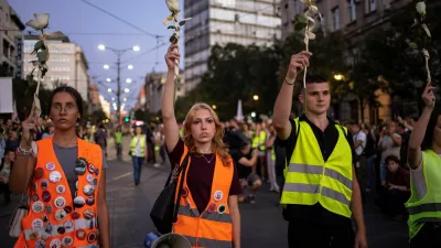Students hold flowers on a street to commemorate the 16 victims, who were killed after a railway concrete canopy fell in November 2024 in Novi Sad, triggering accusations of widespread corruption and negligence, in Belgrade, Serbia, September 1, 2025. REUTERS/Marko Djurica