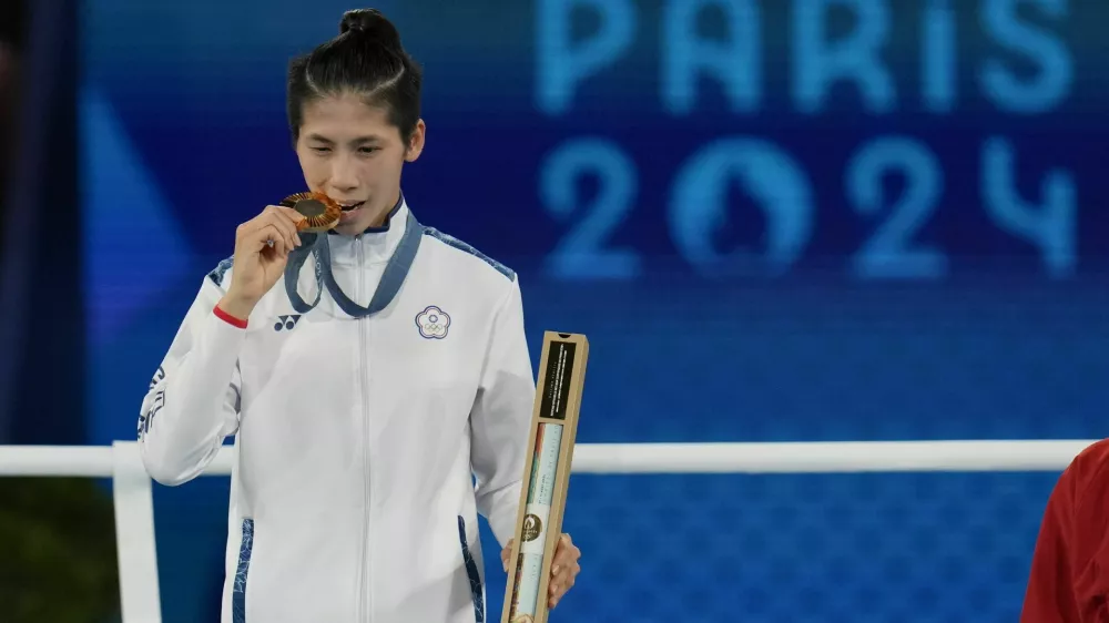 Gold medalist Taiwan's Lin Yu-ting poses during a medals ceremony for the women's 57 kg final boxing match at the 2024 Summer Olympics, Saturday, Aug. 10, 2024, in Paris, France. (AP Photo/Ariana Cubillos)